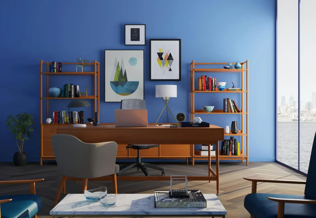 A beautiful study with a blue wall, large windows and beautiful wooden furniture.